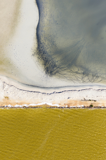 Aerial view of striking contrast between the golden waters and the pale beach a serene coastal landscape San Pedro del Pinatar Region of Murcia Spain. Aerial view of striking contrast between the golden waters and the pale beach a serene coastal landscape San Pedro del Pinatar Region of Murcia Spain.
