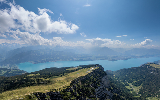 Aerial view of the Niederhorn mountain ridge overlooking the turquoise waters of Lake Thun and the Justistal valley in Sigriswil Bern Switzerland. Aerial view of the Niederhorn mountain ridge overlooking the turquoise waters of Lake Thun and the Justistal valley in Sigriswil Bern Switzerland.