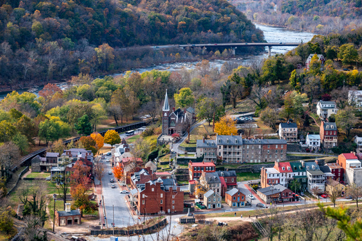 Harpers Ferry United States 16 November 2019 Aerial view of the historic town of Harpers Ferry with stone buildings autumn foliage and a church steeple by the river. Harpers Ferry United States 16 November 2019 Aerial view of the historic town of Harpers Ferry with stone buildings autumn foliage and a church steeple by the river.