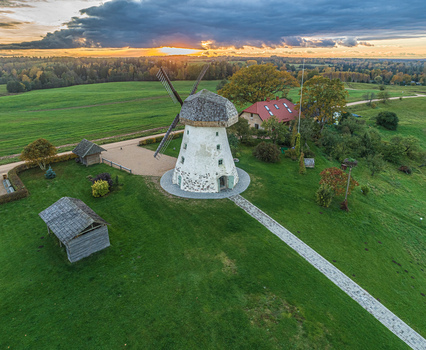 Aerial view of Araisi Windmill surrounded by green fields and trees at sunset in Drabesu pagasts Cesu novads Latvia. Aerial view of Araisi Windmill surrounded by green fields and trees at sunset in Drabesu pagasts Cesu novads Latvia.