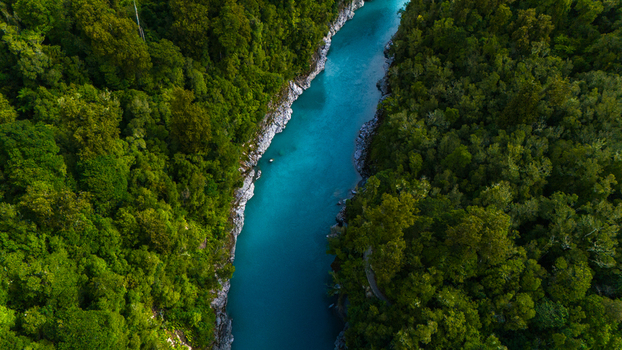 Aerial view of the Hokitika Gorge s turquoise waters winding between the dense verdant rainforest a striking contrast of nature s vibrant hues Hokitika Gorge New Zealand. Aerial view of the Hokitika Gorge s turquoise waters winding between the dense verdant rainforest a striking contrast of nature s vibrant hues Hokitika Gorge New Zealand.