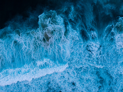 Aerial view of the powerful ocean waves crashing at Sandpatch creating intricate white foam patterns against the deep blue water in Albany Western Australia Australia. Aerial view of the powerful ocean waves crashing at Sandpatch creating intricate white foam patterns against the deep blue water in Albany Western Australia Australia.