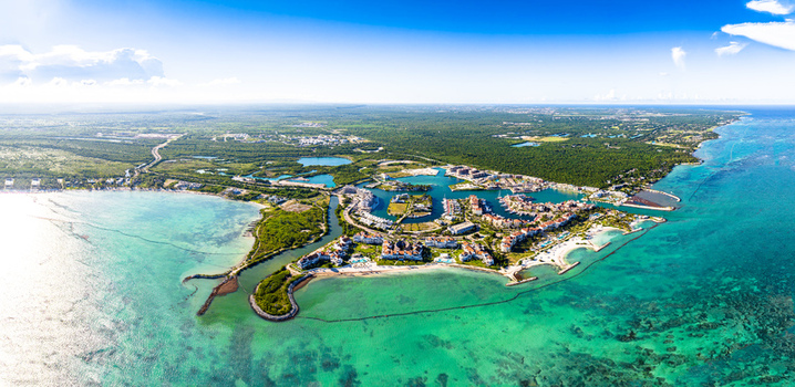 Aerial view of Cap Cana Marina with luxury resorts turquoise Caribbean waters white sandy beaches and lush vegetation in Punta Cana La Altagracia Provinc Dominican Republic. Aerial view of Cap Cana Marina with luxury resorts turquoise Caribbean waters white sandy beaches and lush vegetation in Punta Cana La Altagracia Provinc Dominican Republic.