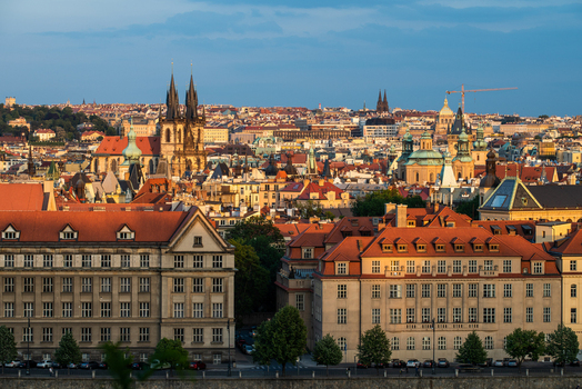 View of the historic skyline of Prague featuring the Church of Our Lady before Tyn with its iconic spires above traditional red tiled rooftops and urban architecture in Prague Prague Czechia.