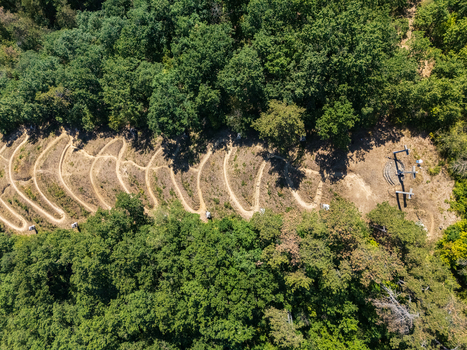 Aerial view of the Three Cross Calvary a Christian hillside monument with winding paths and devotional stations amid summer woodland in Salgotarjan Hungary. Aerial view of the Three Cross Calvary a Christian hillside monument with winding paths and devotional stations amid summer woodland in Salgotarjan Hungary.