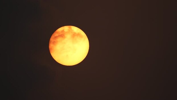 View of the sun glowing through dark clouds Bangladesh.
