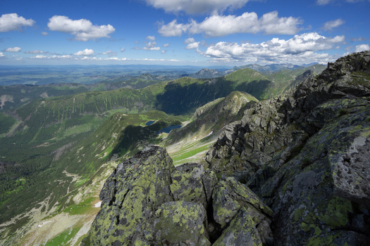 View of Tri kopy in Western Tatras with rugged rocky peaks green alpine valleys and mountain lakes under a blue sky with scattered clouds Ziar Zilina Region Slovakia. View of Tri kopy in Western Tatras with rugged rocky peaks green alpine valleys and mountain lakes under a blue sky with scattered clouds Ziar Zilina Region Slovakia.