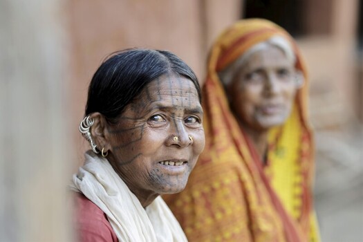 Odisha India 26 March 2026 View of two women one with traditional face tattoos their weathered faces telling stories of resilience against a backdrop of muted earth tones. Odisha India 26 March 2026 View of two women one with traditional face tattoos their weathered faces telling stories of resilience against a backdrop of muted earth tones.