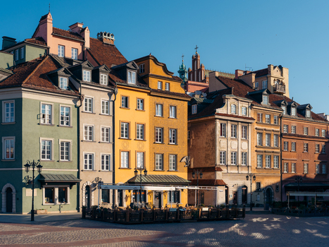 View of the colorful historic buildings in Warsaw Old Town with cobblestone square under a clear blue sky in Warsaw Masovian Voivodeship Poland. View of the colorful historic buildings in Warsaw Old Town with cobblestone square under a clear blue sky in Warsaw Masovian Voivodeship Poland.