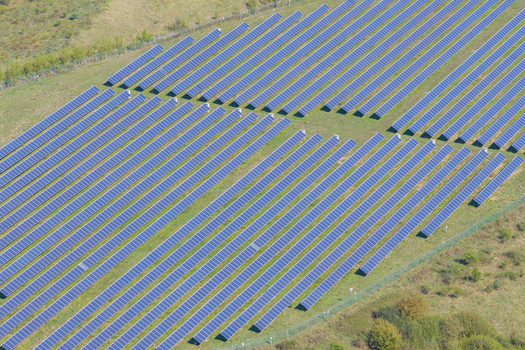 Aerial view of a large solar farm with rows of photovoltaic panels installed in a rural field in Arezzo Tuscany Italy. Aerial view of a large solar farm with rows of photovoltaic panels installed in a rural field in Arezzo Tuscany Italy.