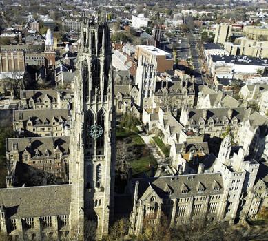 Aerial view of Harkness Tower at Yale University surrounded by historic gothic architecture stone buildings and campus courtyards in New Haven Connecticut United States.