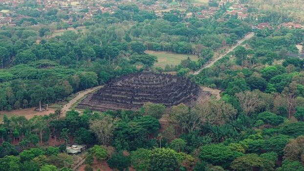 Aerial view of Borobudur Temple in lush forest Indonesia.