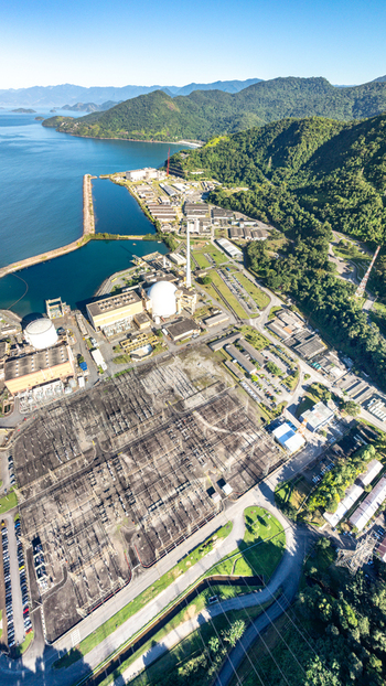 Aerial view of Nuclear Power Plant Angra 2 with its large electrical substation and industrial buildings nestled against mountains in Angra dos Reis Rio de Janeiro Brazil.