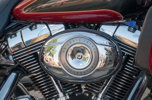 View of a chrome air cleaner cover on a Harley Davidson Electra Glide motorcycle engine with 96 cubic inches displacement and cooling fins in Canada. View of a chrome air cleaner cover on a Harley Davidson Electra Glide motorcycle engine with 96 cubic inches displacement and cooling fins in Canada.