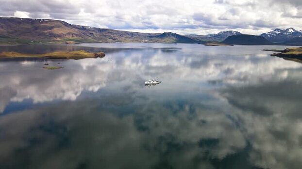 Aerial view of a boat on the calm Hvalfjordur fjord Iceland. Aerial view of a boat on the calm Hvalfjordur fjord Iceland.