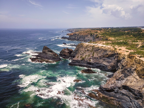 Aerial view of rough sea waves along the coastline in Odeceixe Faro Portugal.