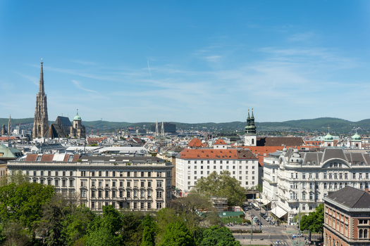 Aerial view of St. Stephen s Cathedral and the historic skyline with green trees and traditional architecture under a clear blue sky in Vienna Vienna Austria. Aerial view of St. Stephen s Cathedral and the historic skyline with green trees and traditional architecture under a clear blue sky in Vienna Vienna Austria.