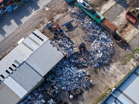 Melbourne VIC Australia 22 September 2026 Aerial view of industrial scrap metal recycling facility in Kilsyth with piles of metal shipping containers and factory buildings. Melbourne VIC Australia 22 September 2026 Aerial view of industrial scrap metal recycling facility in Kilsyth with piles of metal shipping containers and factory buildings.