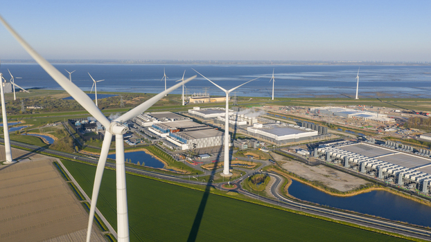 Aerial view of the Google Data Center surrounded by wind turbines and green fields near the coastline in Eemshaven Groningen Netherlands. Aerial view of the Google Data Center surrounded by wind turbines and green fields near the coastline in Eemshaven Groningen Netherlands.