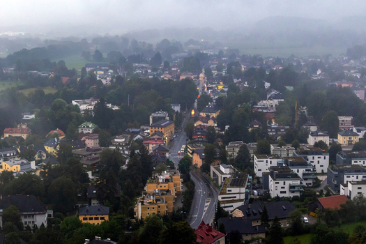 Aerial view of the city of Salzburg with its dense urban architecture winding streets lush green trees and misty atmosphere in Salzburg Salzburg Austria. Aerial view of the city of Salzburg with its dense urban architecture winding streets lush green trees and misty atmosphere in Salzburg Salzburg Austria.
