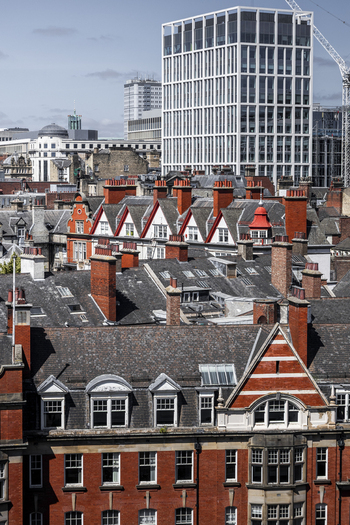 Aerial view of historic red brick rooftops and a modern high rise building in the city center of Newcastle upon Tyne England United Kingdom. Aerial view of historic red brick rooftops and a modern high rise building in the city center of Newcastle upon Tyne England United Kingdom.