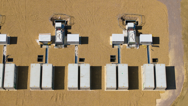 Aerial view of battery energy storage systems and electrical infrastructure at the Eaton Socon Substation with rows of containerized units on a gravel site in St. Neots England United Kingdom. Aerial view of battery energy storage systems and electrical infrastructure at the Eaton Socon Substation with rows of containerized units on a gravel site in St. Neots England United Kingdom.