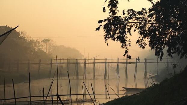 View of a bamboo bridge at sunrise in Bangladesh.