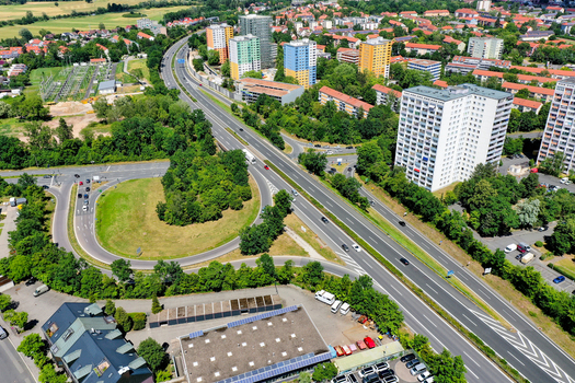 Aerial view of the A73 highway and residential apartment blocks surrounded by lush green trees Nuremberg Bavaria Germany. Aerial view of the A73 highway and residential apartment blocks surrounded by lush green trees Nuremberg Bavaria Germany.
