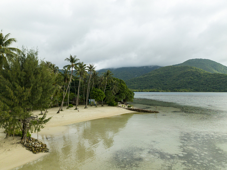 Aerial view of the serene Bobby Beach meets the tranquil sea under a cloudy sky a coastal haven of white sand and green foliage Karimunjawa Jawa Tengah Indonesia.