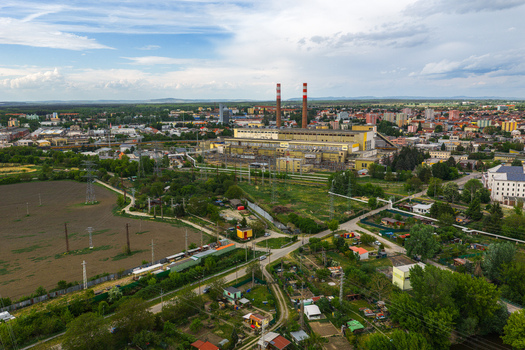 Aerial view of Tepelna elektrarna Hodonin power station with its tall red and white chimneys surrounded by urban buildings and green fields in Hodonin Jihomoravsky kraj Czechia. Aerial view of Tepelna elektrarna Hodonin power station with its tall red and white chimneys surrounded by urban buildings and green fields in Hodonin Jihomoravsky kraj Czechia.