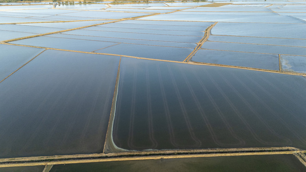 Aerial view of the flooded rice fields of Isla Minima with geometric patterns and water reflections in Coria del Rio Andalusia Spain. Aerial view of the flooded rice fields of Isla Minima with geometric patterns and water reflections in Coria del Rio Andalusia Spain.