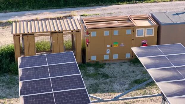 Aerial view of solar panels and utility enclosure in Italy.