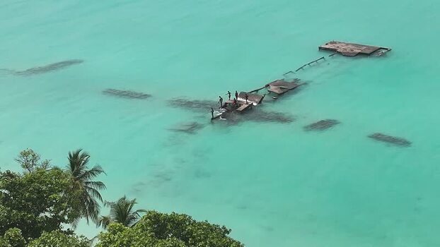 Aerial view of people on a broken wooden pier in turquoise water Maldives. Aerial view of people on a broken wooden pier in turquoise water Maldives.
