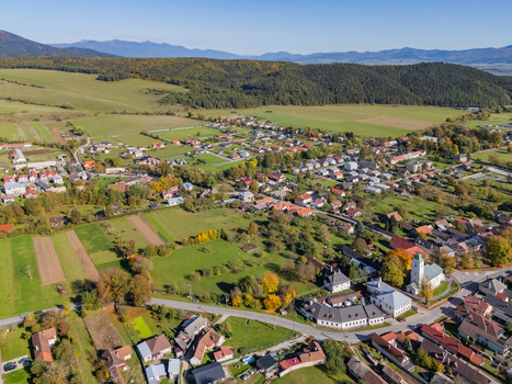 Aerial view of a quaint village nestled among vibrant autumn foliage dominated by a church with a tall white spire Klastor pod Znievom Zilina Region Slovakia. Aerial view of a quaint village nestled among vibrant autumn foliage dominated by a church with a tall white spire Klastor pod Znievom Zilina Region Slovakia.