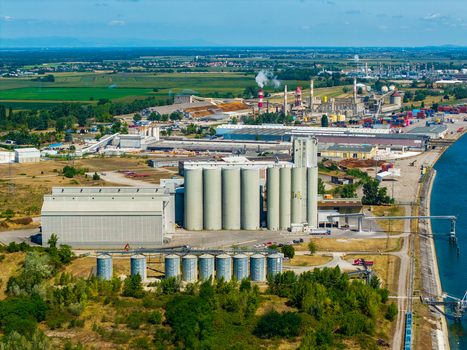Aerial view of industrial grain silos and port facilities situated along a canal in Hombourg Grand Est France.