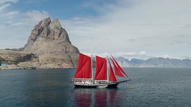Aerial view of sailboat with red sails in Uummannaq Greenland. Aerial view of sailboat with red sails in Uummannaq Greenland.