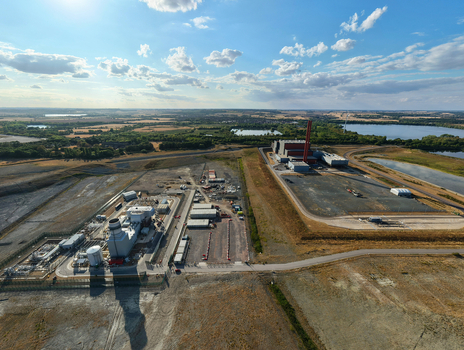 Aerial view of the Rookery South ERF and Millbrook power plant facilities situated in a rural landscape with industrial infrastructure and nearby lakes in Stewartby England United Kingdom.