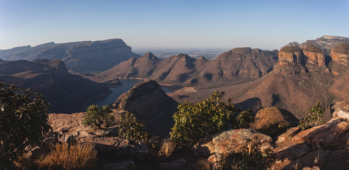 View of the Blyde River Canyon featuring dramatic rocky cliffs a winding river and rugged landscape in South Africa.