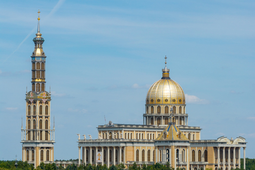 Aerial view of the Basilica of Our Lady of Lichen with its prominent golden dome and tall bell tower under a clear blue sky in Lichen Stary Wielkopolskie Poland. Aerial view of the Basilica of Our Lady of Lichen with its prominent golden dome and tall bell tower under a clear blue sky in Lichen Stary Wielkopolskie Poland.