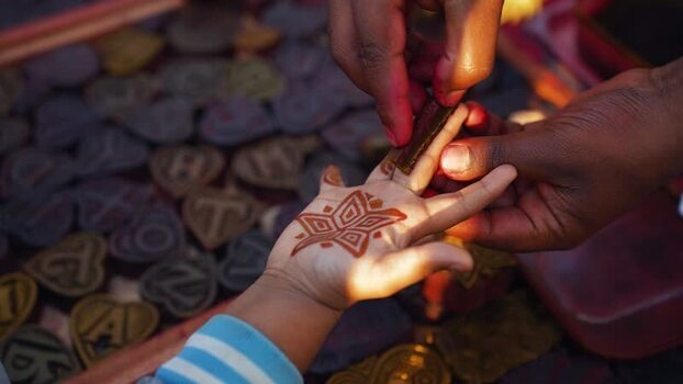 View of hands applying henna to a child s palm Bangladesh. View of hands applying henna to a child s palm Bangladesh.