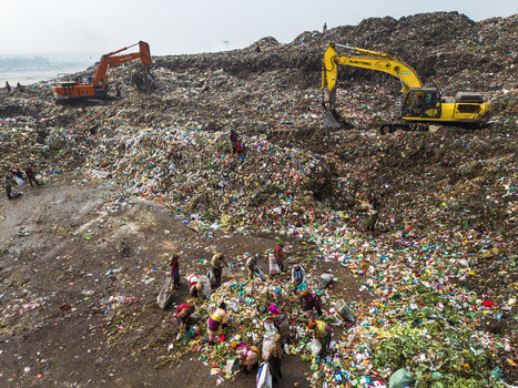 Aminbazar Bangladesh 26 January 2025 Aerial view of Aminbazar landfill with excavators and waste pickers sorting through garbage under a hazy sky. Aminbazar Bangladesh 26 January 2025 Aerial view of Aminbazar landfill with excavators and waste pickers sorting through garbage under a hazy sky.