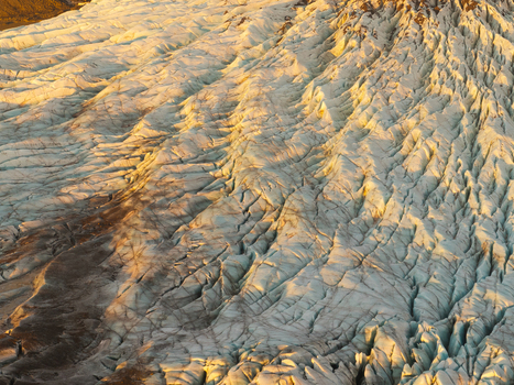 Aerial view of Svinafellsjokull glacier with deep crevasses and golden hour light in Sveitarfelagid Hornafjordur Iceland. Aerial view of Svinafellsjokull glacier with deep crevasses and golden hour light in Sveitarfelagid Hornafjordur Iceland.