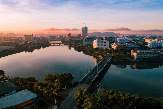 Aerial view of the Iloilo River reflecting the soft hues of dawn framed by the city s skyline and bridges Iloilo City Western Visayas Philippines. Aerial view of the Iloilo River reflecting the soft hues of dawn framed by the city s skyline and bridges Iloilo City Western Visayas Philippines.