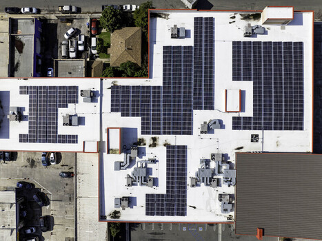 Aerial view of solar panel layout on the rooftop of a commercial business building in Long Beach California United States. Aerial view of solar panel layout on the rooftop of a commercial business building in Long Beach California United States.