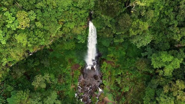 Aerial view of Waterfall Kayu Aro in lush rainforest Indonesia. Aerial view of Waterfall Kayu Aro in lush rainforest Indonesia.