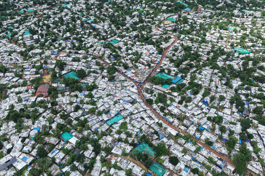 Aerial view of the dense Kutupalang refugee camp with countless makeshift shelters tarpaulin roofs and narrow dirt pathways in Cox s Bazar District Chittagong Division Bangladesh.