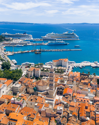 Aerial view of the historic old town and Cathedral of Saint Domnius bell tower overlooking the harbor with cruise ships and ferries in Split Split Dalmatia County Croatia. Aerial view of the historic old town and Cathedral of Saint Domnius bell tower overlooking the harbor with cruise ships and ferries in Split Split Dalmatia County Croatia.