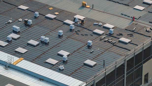 Loriol sur Drome France 26 July 2026 Aerial view of a modern industrial warehouse under construction featuring roofing works with skylights waterproofing membrane and insulation materials.