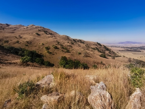 View of the rugged hills and dry grass landscape of the Badplaas area in eManzana Mpumalanga South Africa. View of the rugged hills and dry grass landscape of the Badplaas area in eManzana Mpumalanga South Africa.