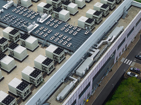 Aerial view of a data center roof featuring numerous HVAC cooling units and ventilation systems in the United Kingdom.